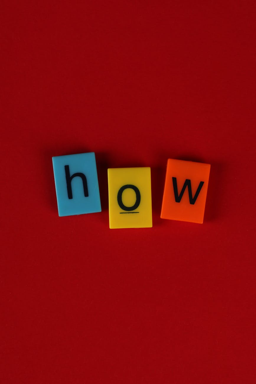 colorful letter tiles spelling how on red